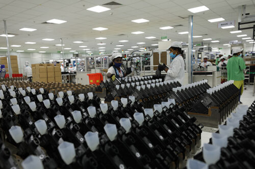 Workers at a factory making Enphase microinverters.