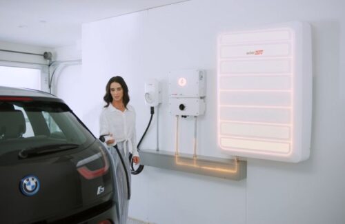 SolarEdge’s inverter-integrated charger is installed in the garage between a battery and mount for the handle