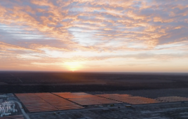A photo of a utility-scale solar project shot at sunset.