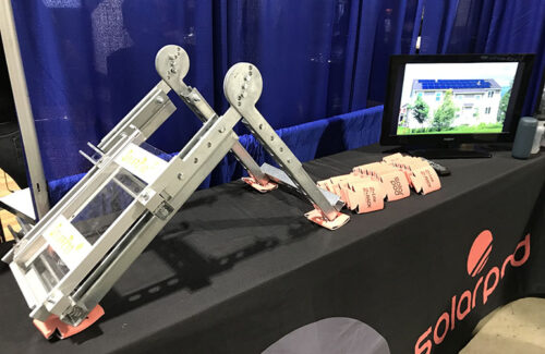 Solar racking set atop a table covered in a branded tablecloth.